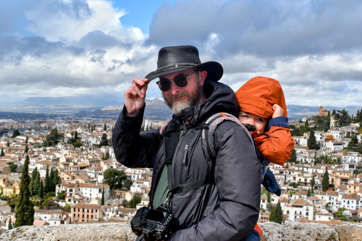 Portrait of the photographer against a backdrop of houses.